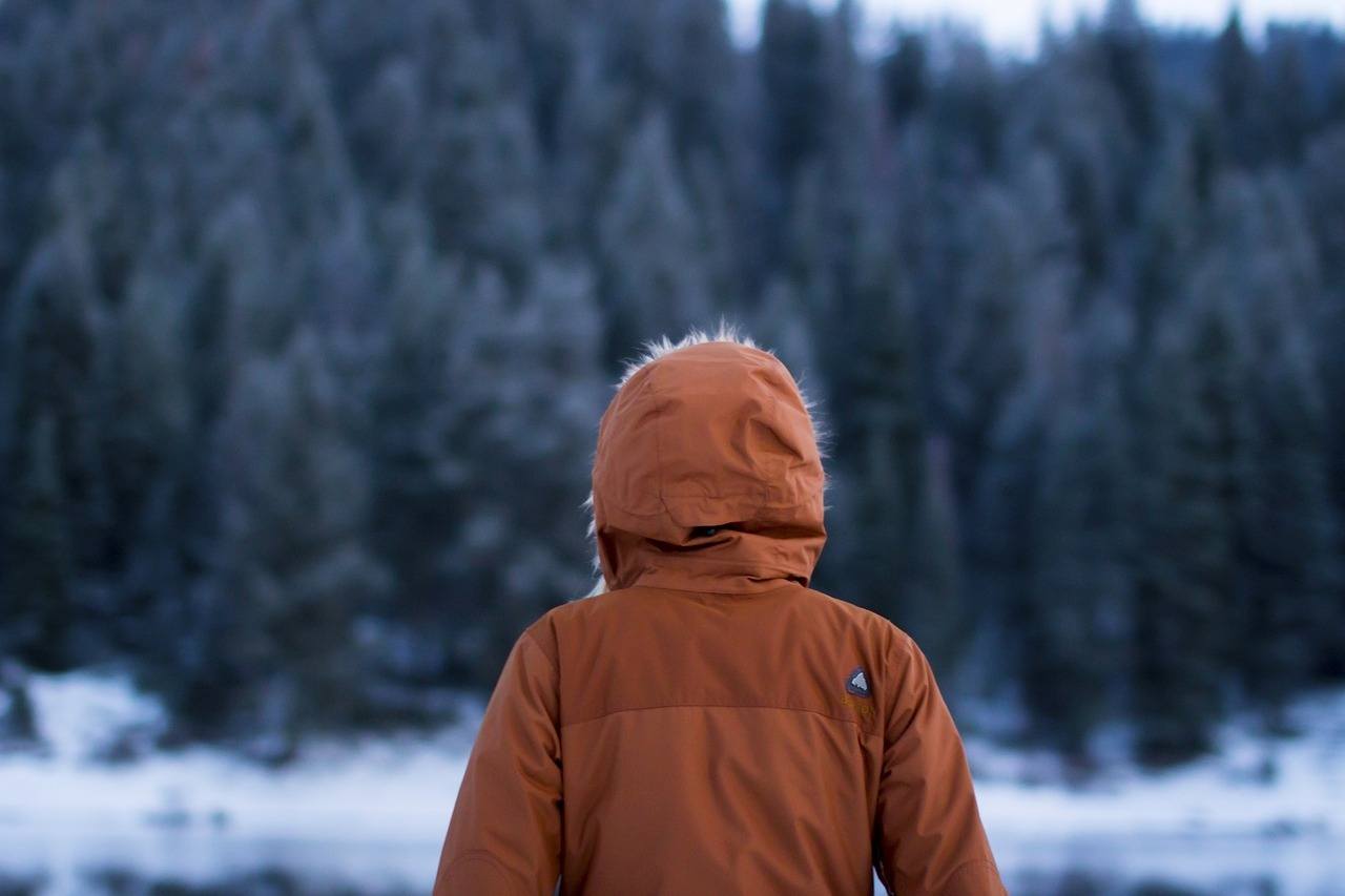 Menschliche Jacke im Winter allein auf der Straße in einem kalten Wald